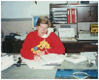 Joanne behind desk